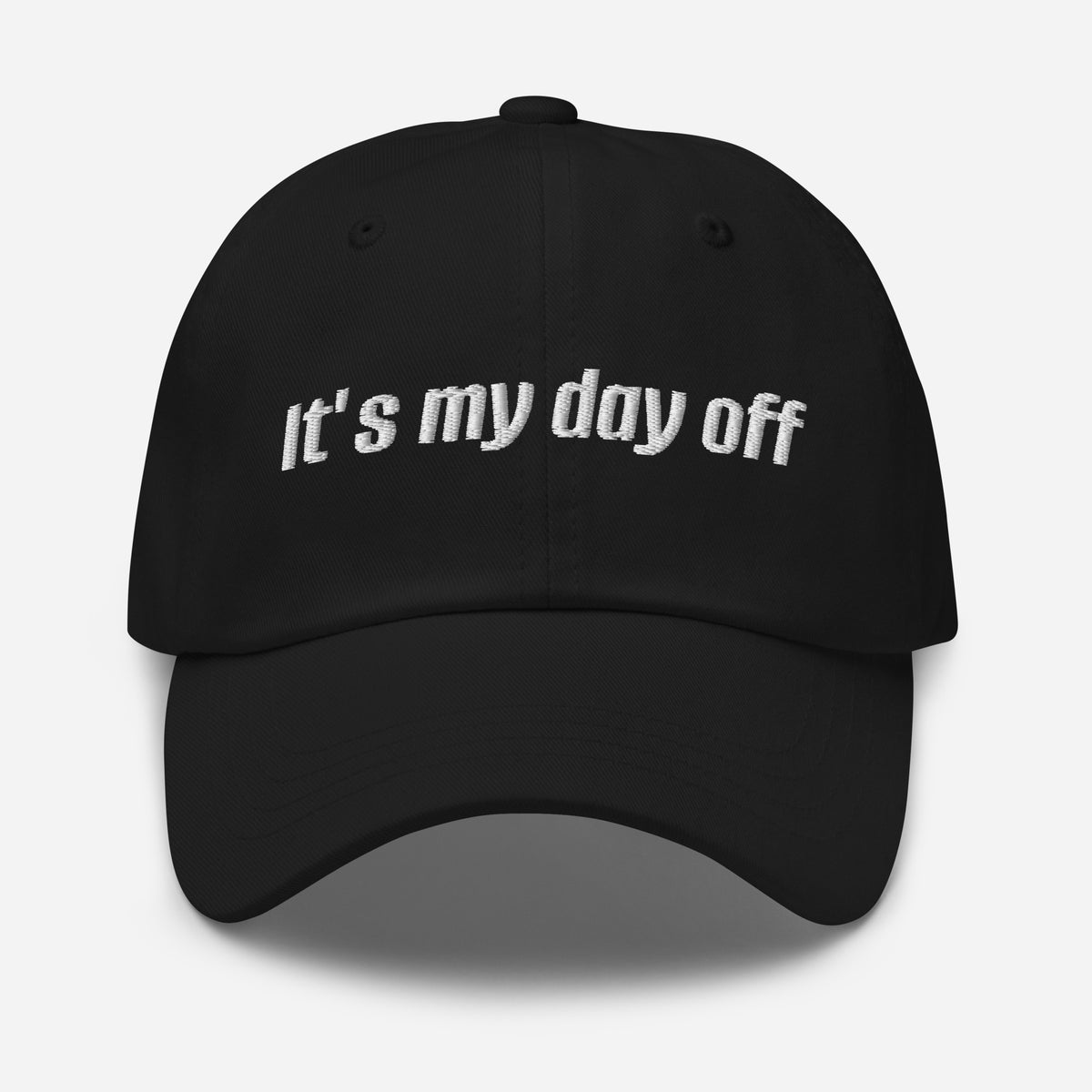 Black cap with 'It's my day off' text on a white background
